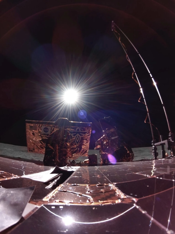 A bright burst of light shines from the edge of a dark disk, creating a dramatic contrast against the black sky.